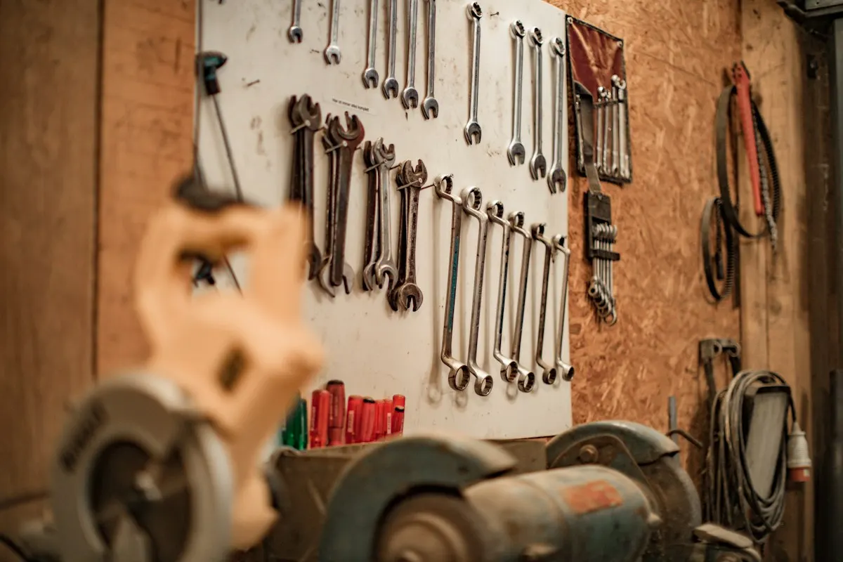 Wrenches and hand tools hung on a workshop wall
