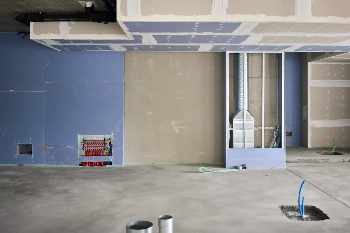 Drywall sheets and finished joints in a room under renovation