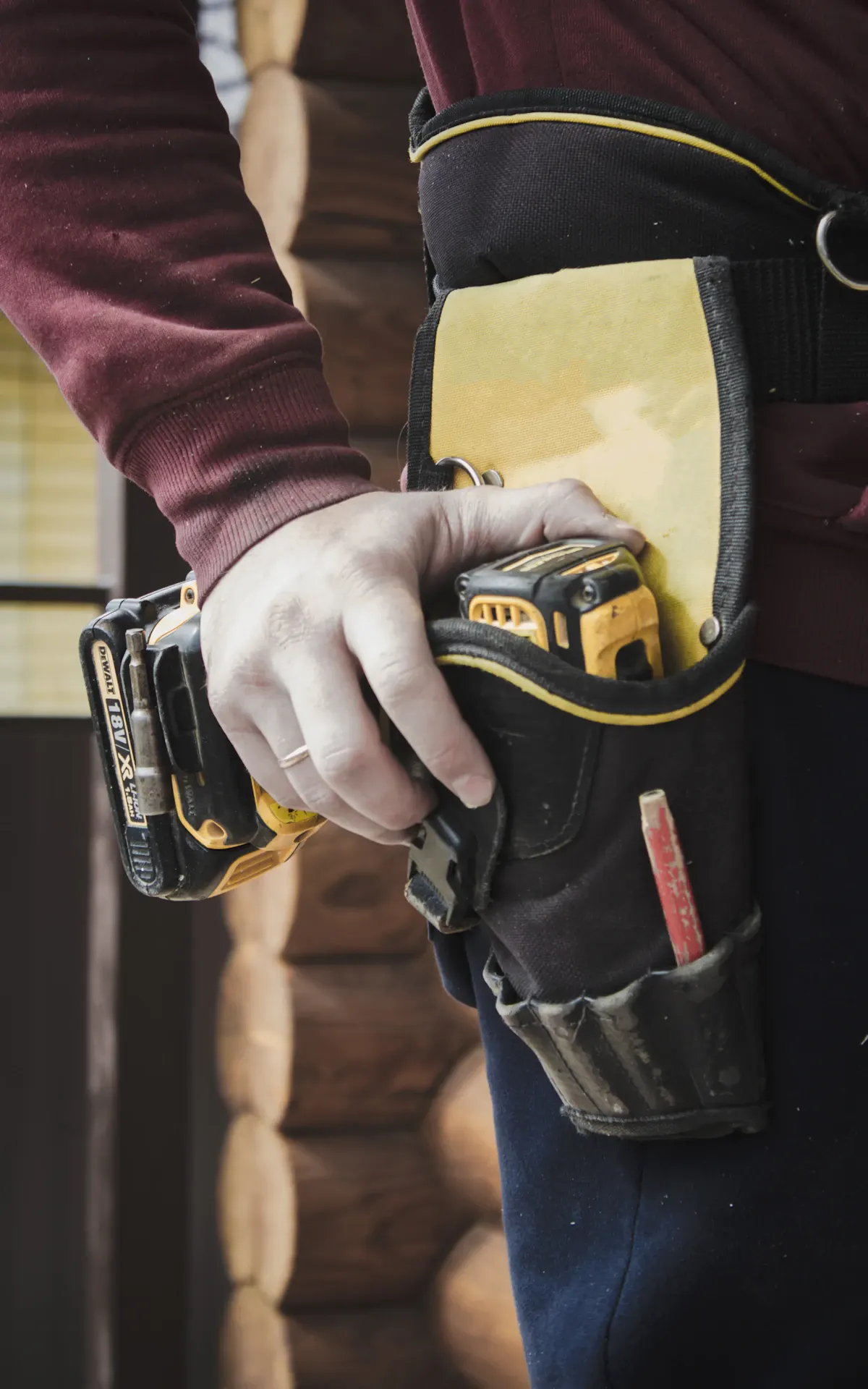 Worker's tool belt with a tape measure and hand tools